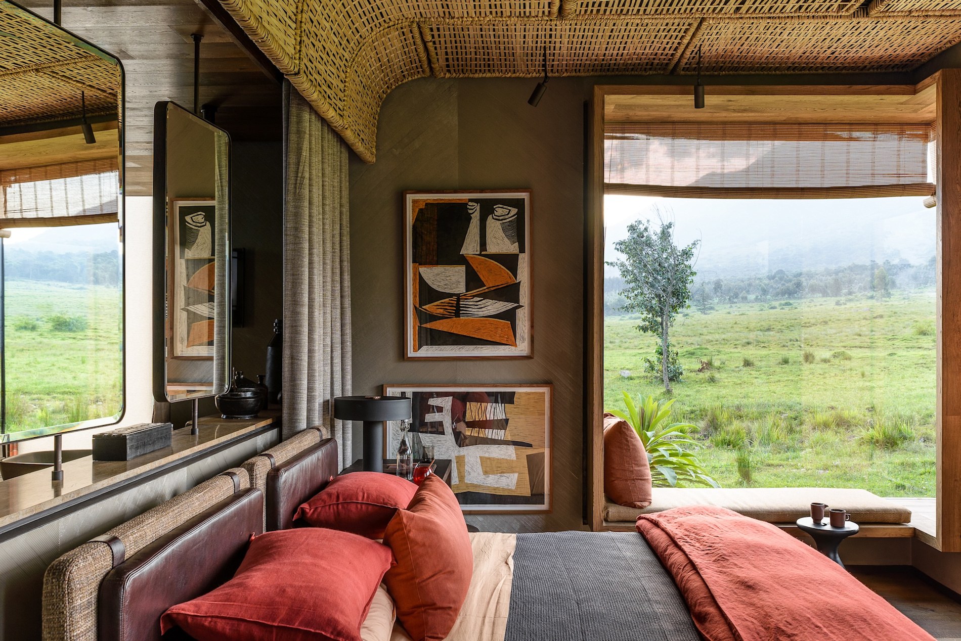 Kwitonda interior of one bedroom suite with dark orange bedding adriaan louw